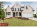 Charming brick home features a manicured lawn, black window shutters, and attached garage at 1077 Sweet Mia Ln, Powder Springs, GA 30127