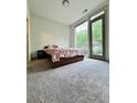 Cozy bedroom with large windows, balcony access, and soft gray carpet at 1153 Reynolds Square Ln # 16, Atlanta, GA 30307