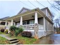 Inviting home featuring a covered front porch with ceiling fans and tasteful landscaping at 2132 Memorial Se Dr, Atlanta, GA 30317