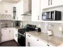 Well-equipped kitchen with stainless steel appliances, light countertops, and ample cabinet space at 2132 Memorial Se Dr, Atlanta, GA 30317