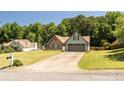 Well-maintained single-Gathering home featuring a landscaped lawn, brick accents, and a spacious two-car garage at 3335 Ivy Lake Dr, Buford, GA 30519