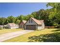 Landscaped single-Gathering home with brick accents, a two-car garage and a spacious front lawn at 3335 Ivy Lake Dr, Buford, GA 30519