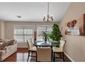 Dining area with a glass table, four chairs, ample sunlight, and an adjacent living room at 805 Pleasant Hill Nw Rd # 343, Lilburn, GA 30047