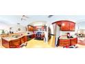 Spacious kitchen featuring stainless steel appliances, granite countertops and red-toned wooden cabinets at 805 Pleasant Hill Nw Rd # 343, Lilburn, GA 30047