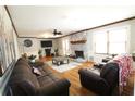 Spacious living room with hardwood floors, fireplace, ceiling fan, and wainscoting at , Loganville, GA 30052