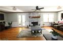 Bright living room features a decorative fireplace, hardwood floors, and a ceiling fan at , Loganville, GA 30052