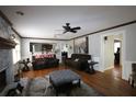 The living room showcases hardwood floors, a ceiling fan, and an adjacent kitchen at , Loganville, GA 30052