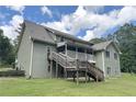 Rear exterior featuring a wooden deck with stair access and a spacious yard at 3133 Callie Still Rd, Lawrenceville, GA 30045