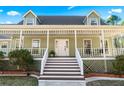 Inviting front porch with classic columns and ample space for relaxing and enjoying the outdoors at 3133 Callie Still Rd, Lawrenceville, GA 30045