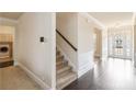 Elegant foyer featuring hardwood floors, stairs, and a view of the front entrance at 3823 Dragon Fly Ln, Loganville, GA 30052
