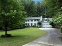 Two-story home featuring a manicured lawn, two-car garage, and mature trees at 517 Sheritan Sw Way, Smyrna, GA 30082