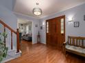 A welcoming foyer with hardwood floors, a staircase, and a view into a living area at 517 Sheritan Sw Way, Smyrna, GA 30082