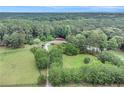 Expansive aerial view of a secluded home surrounded by lush greenery and a well-maintained landscape at 2452 Camp Mitchell Rd, Grayson, GA 30017