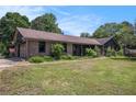 Well-maintained brick house with a spacious front yard and established landscaping under a clear sky at 2452 Camp Mitchell Rd, Grayson, GA 30017