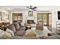 Cozy living room featuring a brick fireplace, wood floors, and ample natural light with stylish decor and furnishings at 2452 Camp Mitchell Rd, Grayson, GA 30017