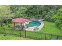 Pool area featuring a covered structure, a picnic table and a metal fence at 2452 Camp Mitchell Rd, Grayson, GA 30017