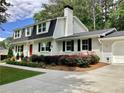 Beautifully landscaped home with a red front door and a two-car garage at 2917 Townley Cir, Atlanta, GA 30340