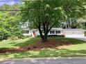 A large tree sits in the front yard of a charming home with a two-car garage at 2917 Townley Cir, Atlanta, GA 30340