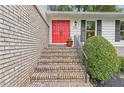 Close-up of the front entrance, showcasing the brick steps and the bold red double doors at 3751 Cherokee Se Pl, Marietta, GA 30067