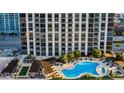 Exterior building view with a swimming pool, lounge chairs and cabanas on a sunny day at 270 17Th Nw St # 3606, Atlanta, GA 30363