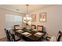 Elegant dining room featuring a dark wood table, decorative artwork, and stylish chandelier at 6245 Hickory Lane Cir, Union City, GA 30291