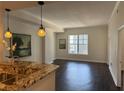 Bright living room featuring hardwood floors, modern lighting and an open concept connecting to the kitchen bar at 1101 Juniper Ne St # 1506, Atlanta, GA 30309