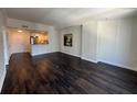 Open-concept living area with hardwood floors adjacent to the kitchen and entryway at 1101 Juniper Ne St # 1506, Atlanta, GA 30309