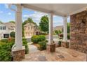 Inviting front porch with stone accents and view of the beautifully landscaped neighborhood at 4230 Glen Vista Ct, Duluth, GA 30097