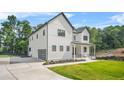 Striking two-story home with a black framed garage door and a lush green yard at 5175 Cascade Rd, Atlanta, GA 30331