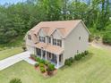 An elevated view of a two-story home with well-maintained landscaping and a spacious lawn at 871 Wisteria View Ct, Dacula, GA 30019