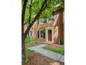 Charming brick home featuring a red front door with a wreath and a well-manicured lawn at 1092 Old Roswell Rd, Roswell, GA 30076