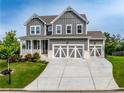 Charming two-story home featuring a gray facade, white trim, a well-manicured lawn, and a driveway at 17 Ridgeline Nw Way, Cartersville, GA 30121