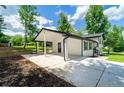 A side view of the home features a convenient carport and fresh landscaping at 550 Oglesby Bridge Se Rd, Conyers, GA 30094