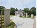 Long driveway leading to a beautifully designed home with an attached three-car garage at 1461 Leach Dr, Lawrenceville, GA 30045