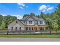 Beautiful two-story home with white brick, siding and a black wooden fence outlining the front yard at 1461 Leach Dr, Lawrenceville, GA 30045