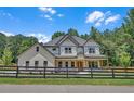 Charming two-story home with a modern farmhouse design, fenced yard, and beautifully maintained landscaping at 1461 Leach Dr, Lawrenceville, GA 30045