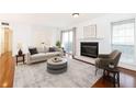 Bright living room featuring a fireplace, neutral decor, and access to the balcony at 2901 Lenox Ne Way # 902, Atlanta, GA 30324