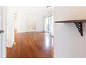 Open living area with gleaming hardwood floors and access to a patio at 2901 Lenox Ne Way # 902, Atlanta, GA 30324