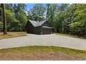 Exterior of a craftsman home surrounded by mature trees and landscaping at 1687 Harmony Rd, Temple, GA 30179