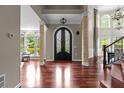Grand foyer with hardwood floors, soaring ceilings, transom windows and decorative ironwork double doors at 2990 Hearthstone Dr, Cumming, GA 30041