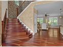 Staircase features hardwood steps, custom railing, and brick wall accent in this beautiful home at 2990 Hearthstone Dr, Cumming, GA 30041
