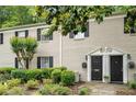 Charming two-story townhome featuring black shutters, well maintained lawn, and a landscaped front yard at 3663 Essex Ave # 29, Atlanta, GA 30339