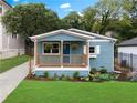 Beautifully renovated bungalow showcasing a quaint porch, blue facade, and professionally landscaped garden at 75 Mayson Ne Ave, Atlanta, GA 30307