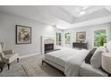 Serene main bedroom with a fireplace, tray ceiling, and access to a private deck at 110 Westchester Way, Alpharetta, GA 30005