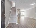 Inviting entryway with hardwood floors and staircase leading to the upper level at 2566 Walden Lake Dr, Decatur, GA 30035