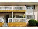 Multi-Gathering home with white siding, a covered balcony, designated parking, and mature trees at 1990 Wellbourne Dr # 5, Atlanta, GA 30324