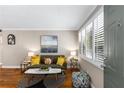 Cozy living room featuring hardwood floors, neutral walls, plantation shutters, and modern decor at 1990 Wellbourne Dr # 5, Atlanta, GA 30324
