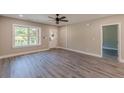 This is a vacant bright living room with a ceiling fan and large window at 3275 Dodson Dr, East Point, GA 30344