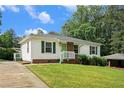 Charming single-story home featuring a well-manicured lawn, white siding, and green accents, perfect for cozy living at 3650 Croft Nw Pl, Atlanta, GA 30331