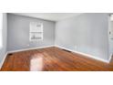 The bright living room has hardwood floors, light-gray walls and a window, making it a comfortable place to relax at 3650 Croft Nw Pl, Atlanta, GA 30331